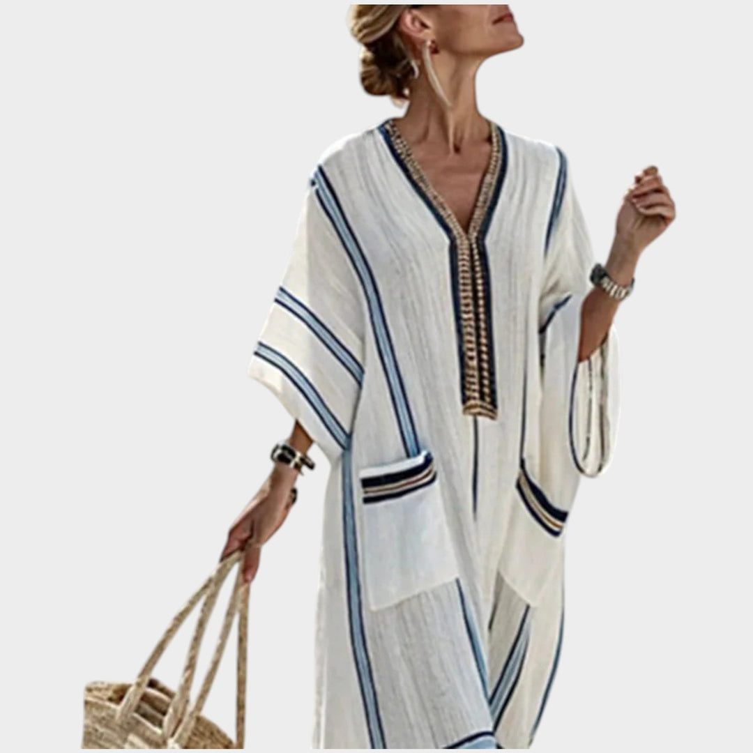 Close-up view of the white maxi dress showcasing the V-neckline and striped accents