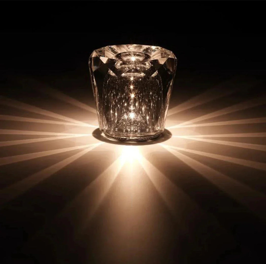 Faceted crystal table lamp glowing in a dark room