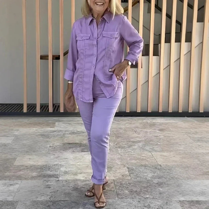 Full-length view of a woman modelling a purple matching button shirt and pants outfit