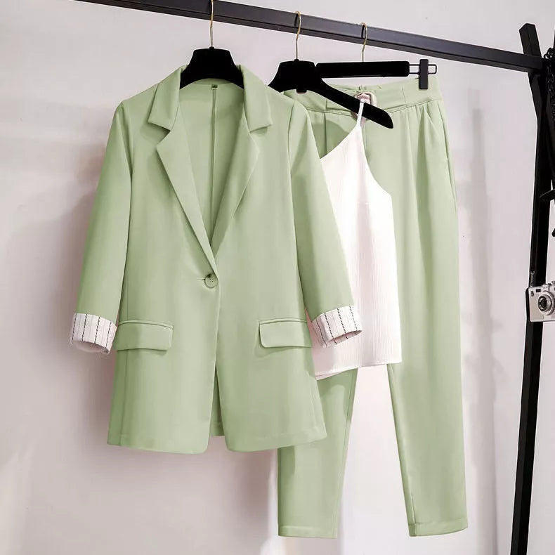Green women's three-piece blazer suit set with matching trousers and top