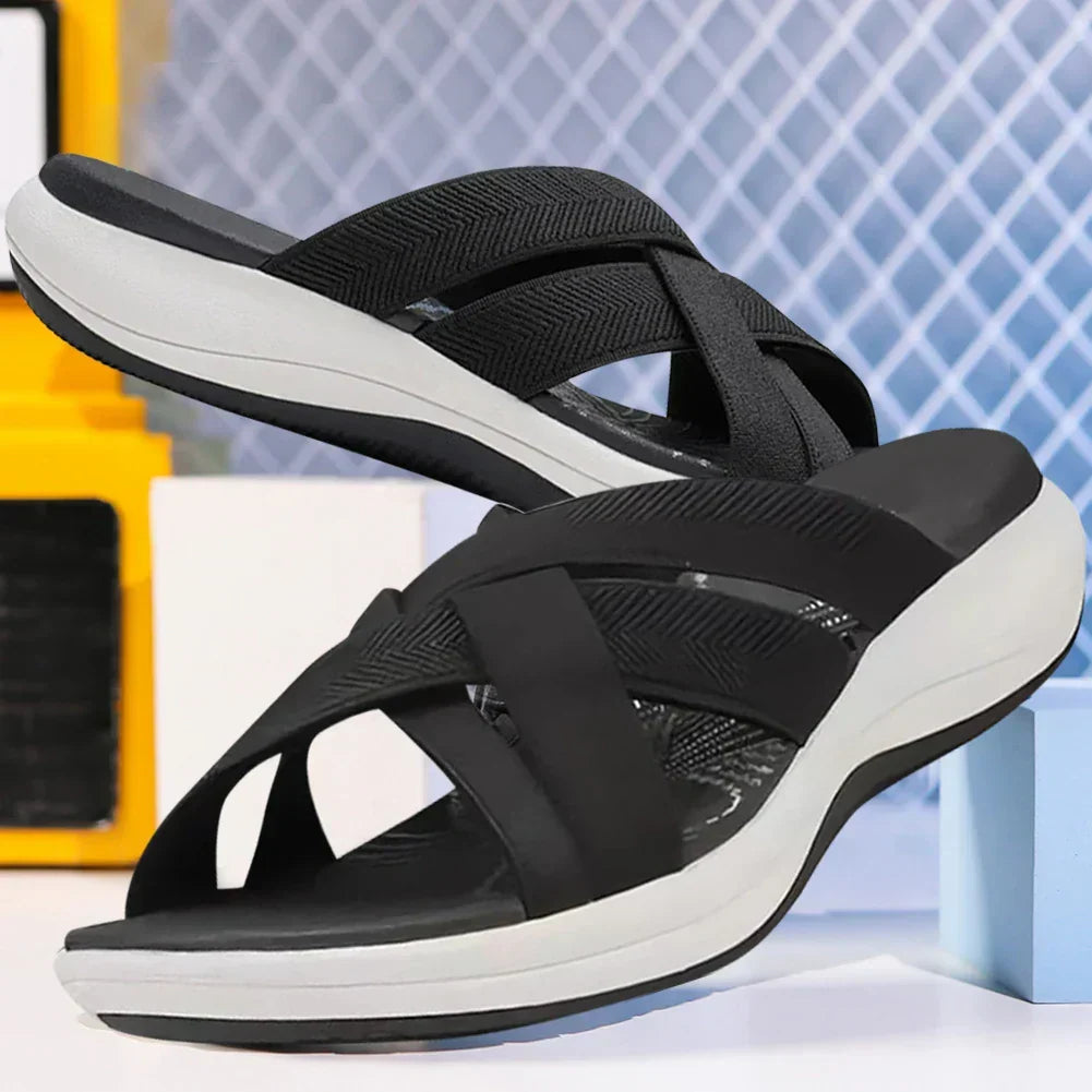 Side angle view of black ergonomic slide sandals