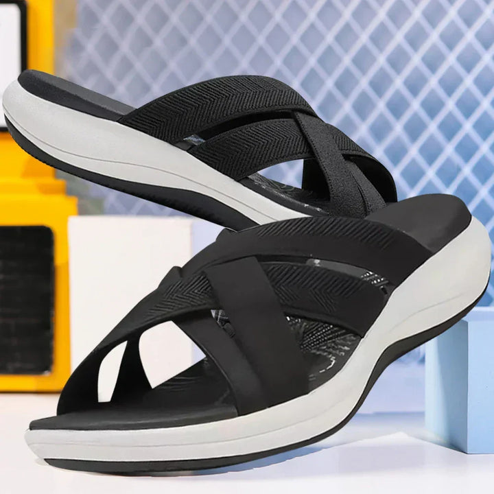 Side angle view of black ergonomic slide sandals