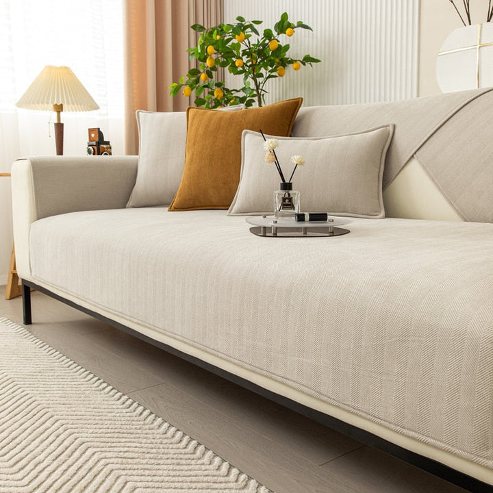 Beige non-slip chenille sofa cover with decorative pillows