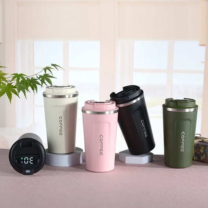 Assorted thermal mugs in various colors displayed alongside a separate lid showing digital temperature