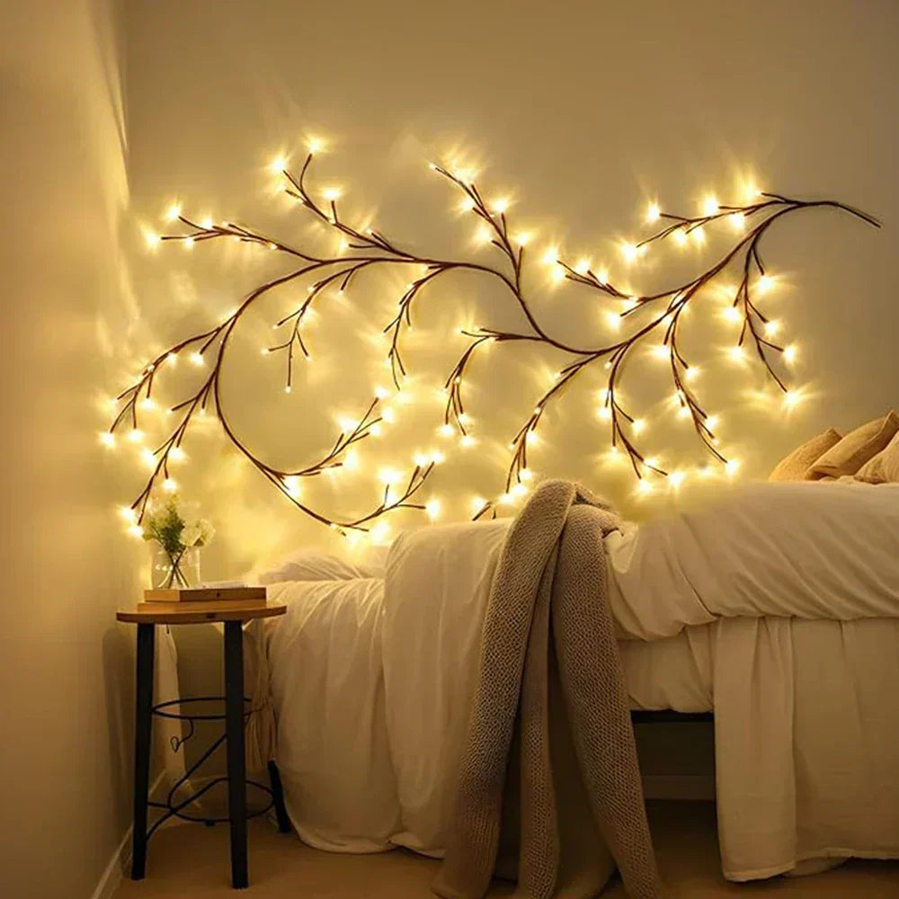 Illuminated LED branch lights mounted above a bed frame in a cozy bedroom