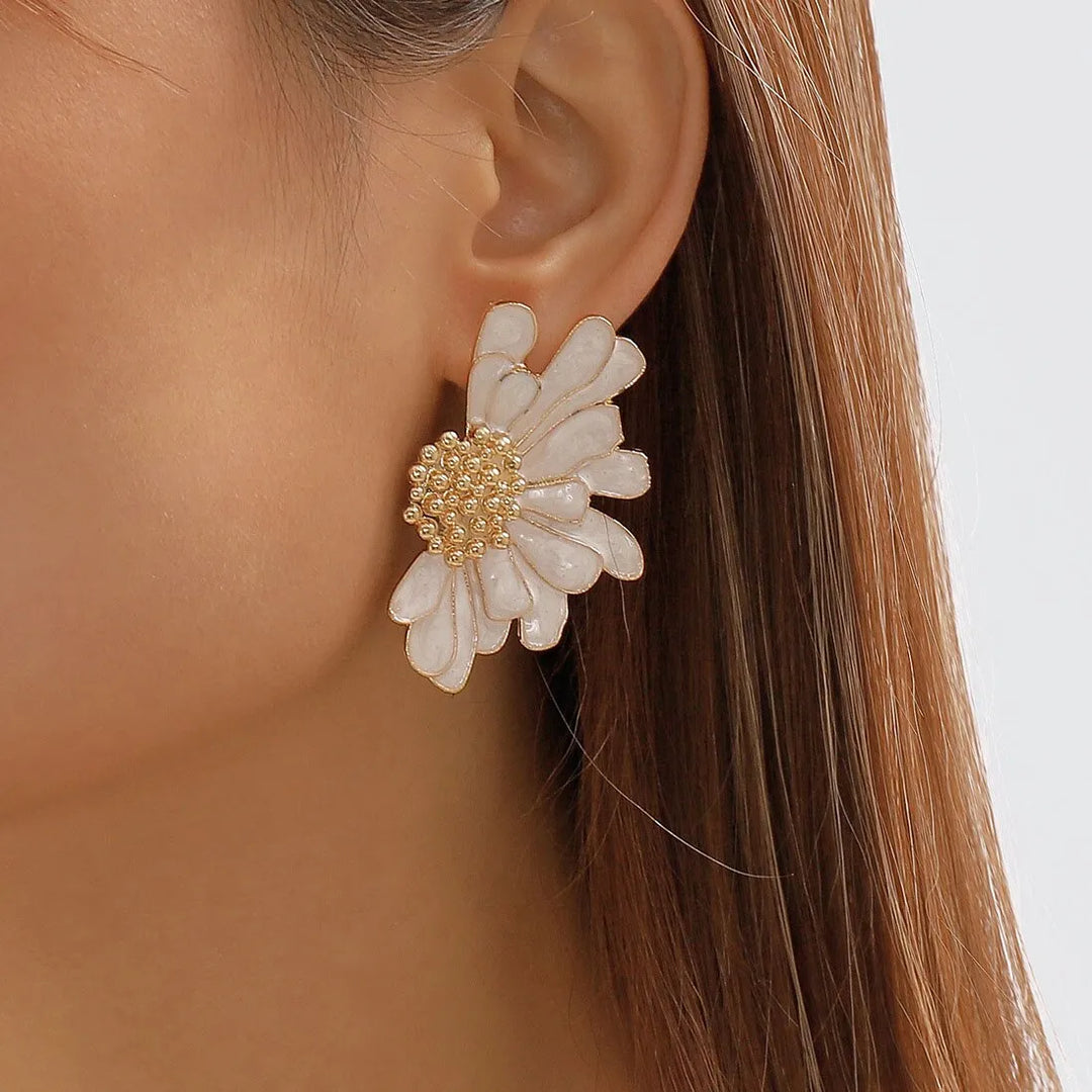 Model wearing white petal statement earrings