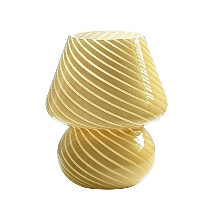 Retro glass mushroom lamp lit up on a bedside table for cozy bedroom decor lighting