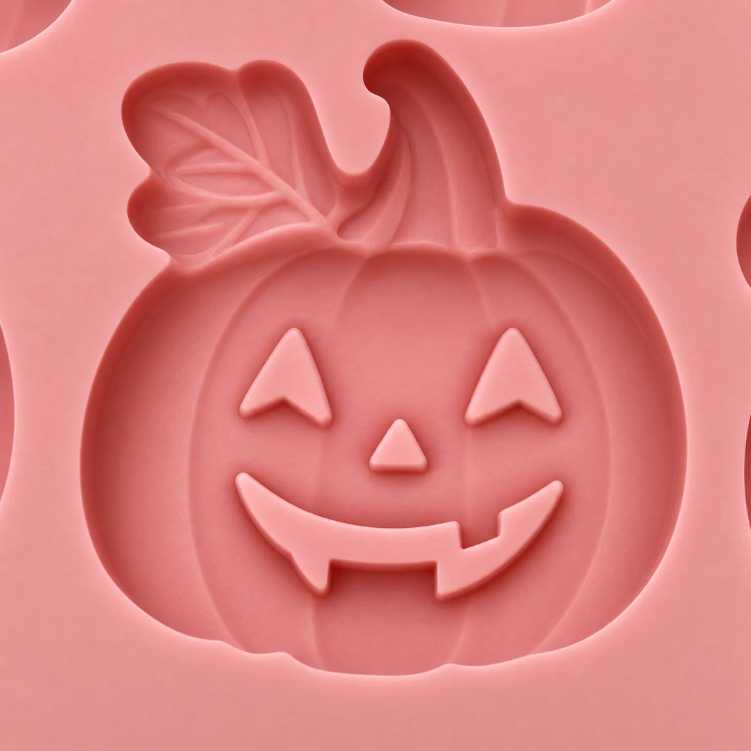 Set of two orange silicone trays shaped like pumpkins for spooky party baking