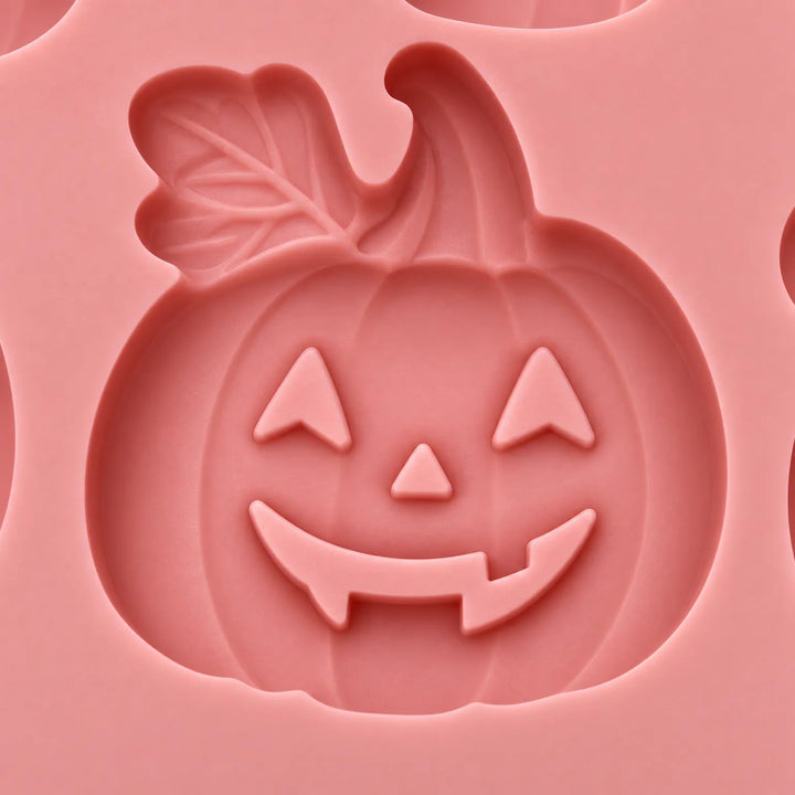 Set of two orange silicone trays shaped like pumpkins for spooky party baking