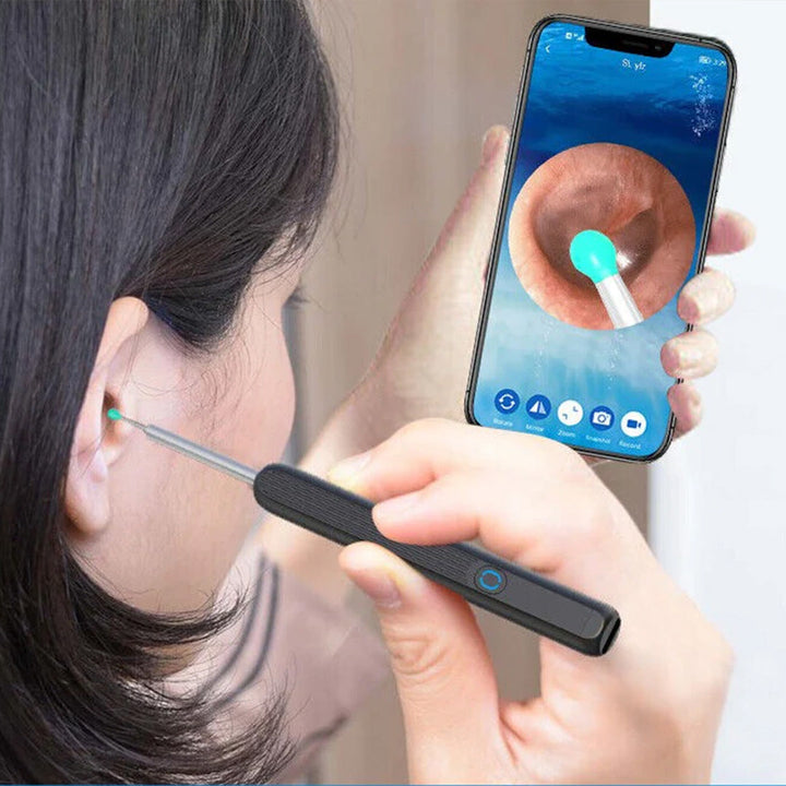 Person using smart ear wax cleaner while viewing live feed on smartphone