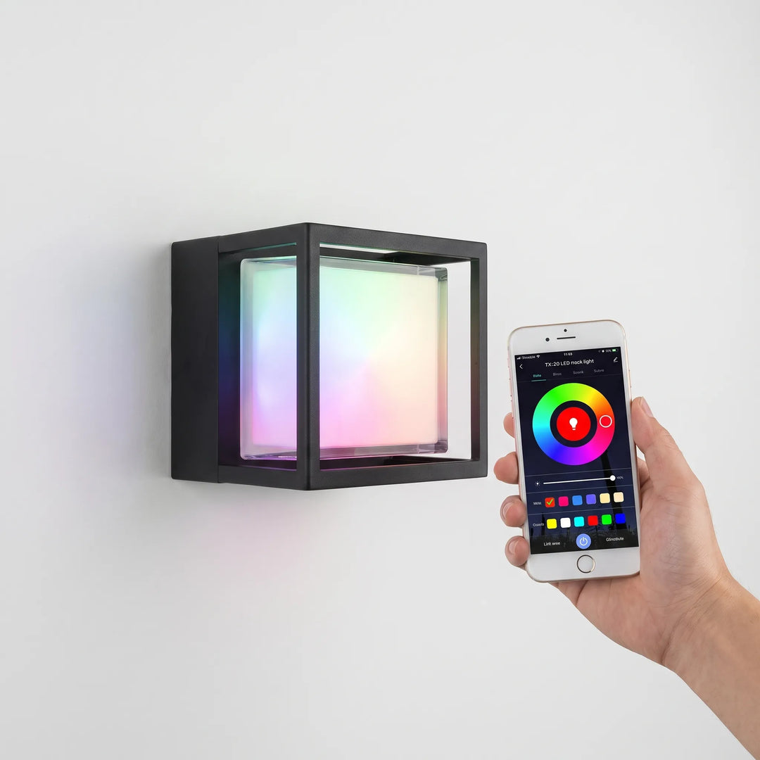 Hand holding a smartphone app controlling the RGB color settings of the wall light.