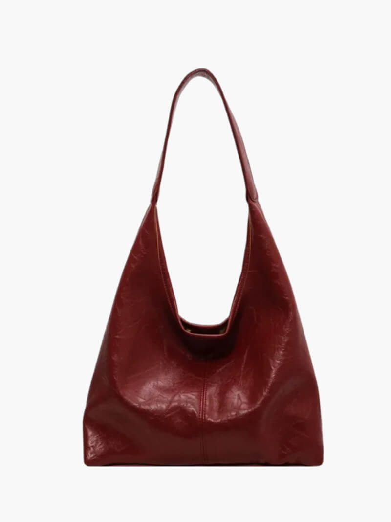 Luxury brown leather women handbag featuring a sleek shoulder strap design