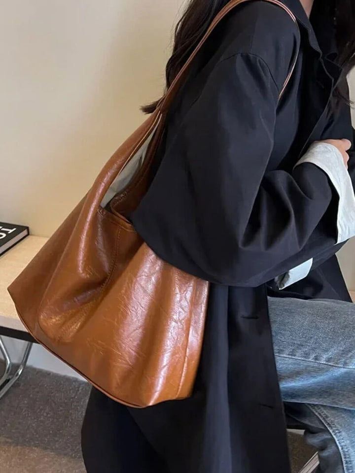 Side profile of the luxury fashion handbag highlighting its structured shape