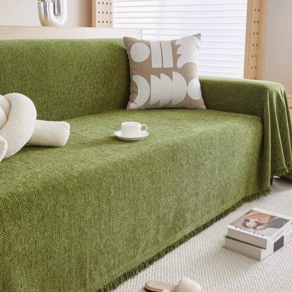Green modern sofa throw blanket draped over a living room couch