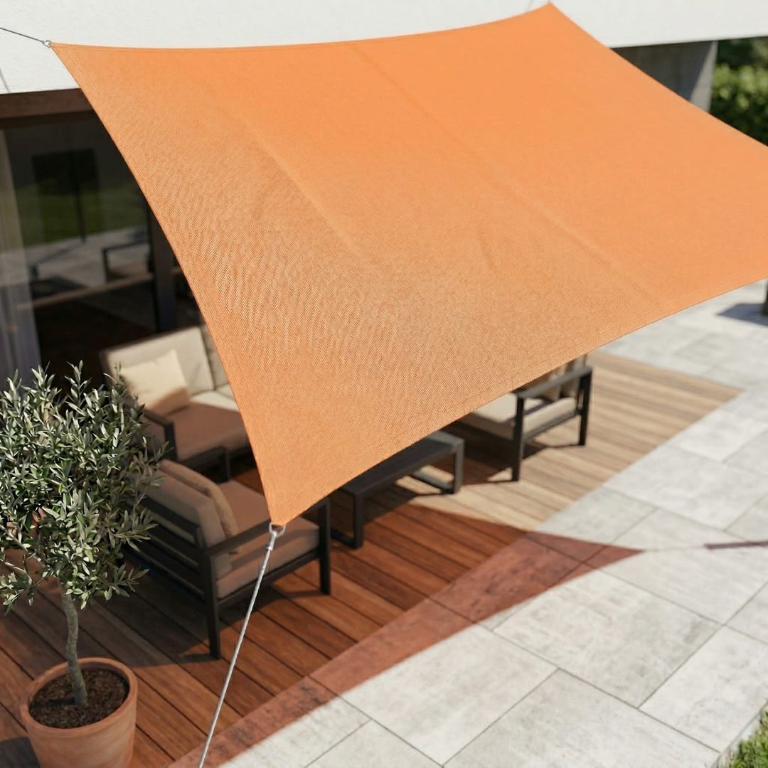 Sand-colored patio shade sail mounted securely between wooden pergola posts