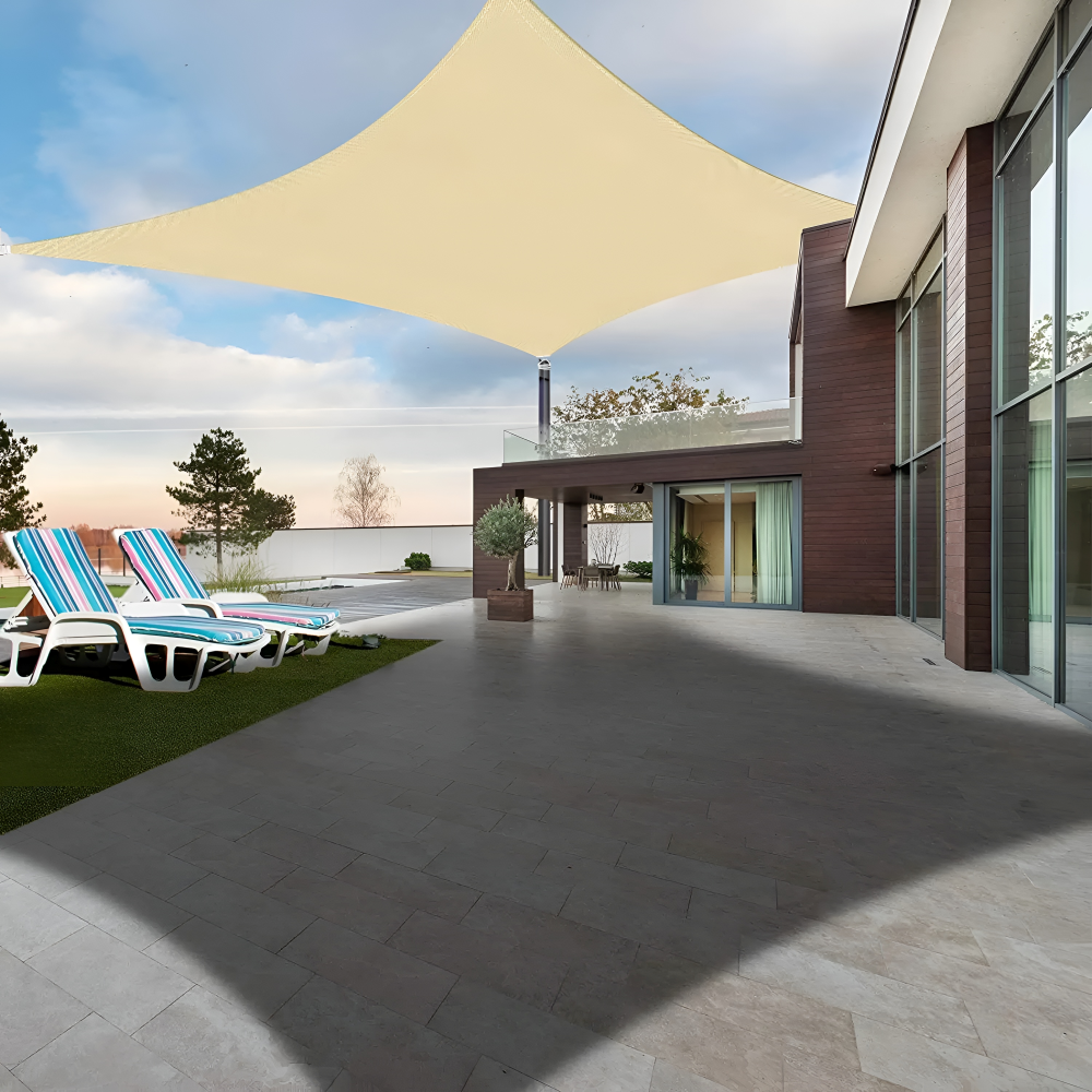 Beige shade sail providing large shaded patio space next to a contemporary house