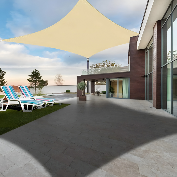Beige shade sail providing large shaded patio space next to a contemporary house