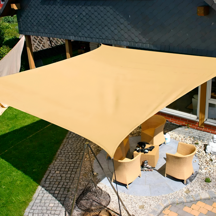 Waterproof rectangular outdoor shade sail in beige installed over a sunny patio