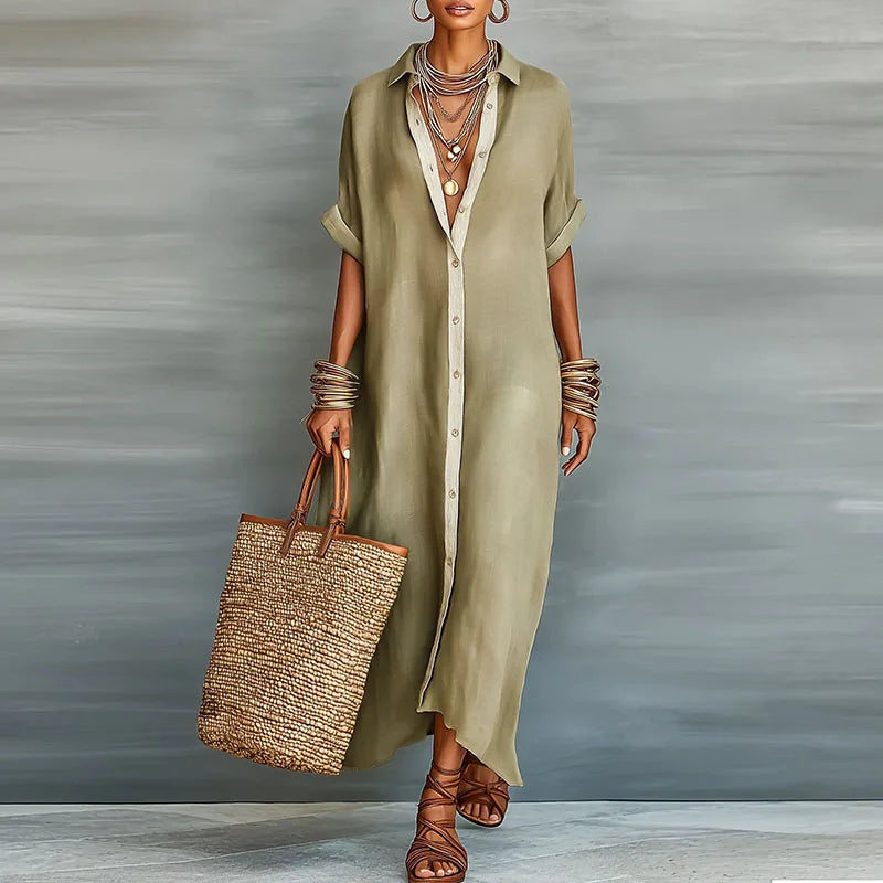 Model wearing a khaki button-down maxi shirt dress with accessories and a straw bag
