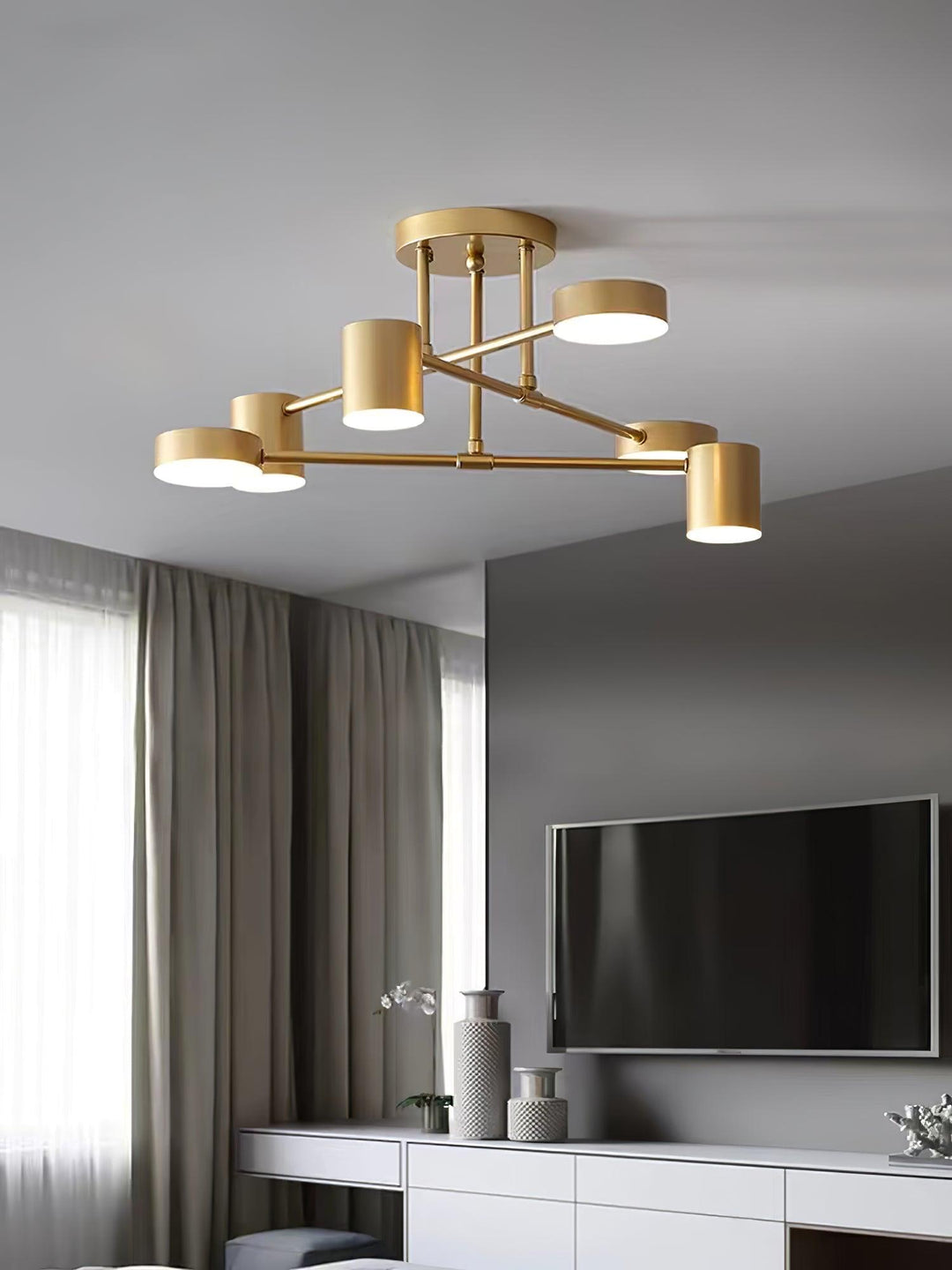 Elegant modern gold ceiling light illuminating a stylish apartment interior