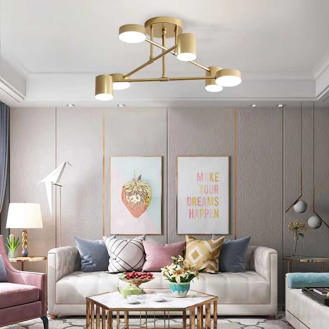 Close-up view of the multi-directional cylindrical light points on the gold ceiling fixture