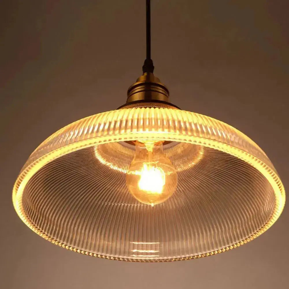Vintage glass pendant light glowing with a warm amber tone