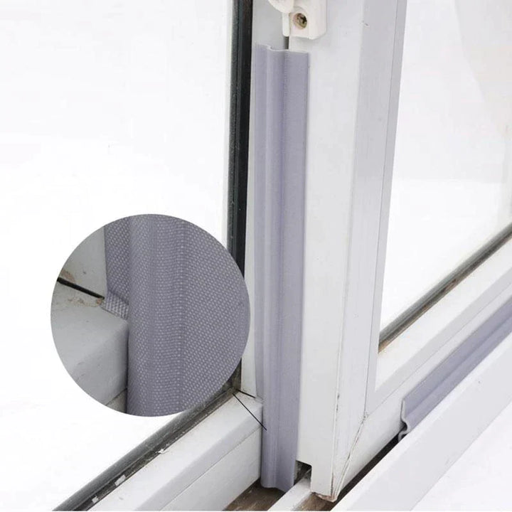 Close-up of soundproofing draft seal strip blocking light under door