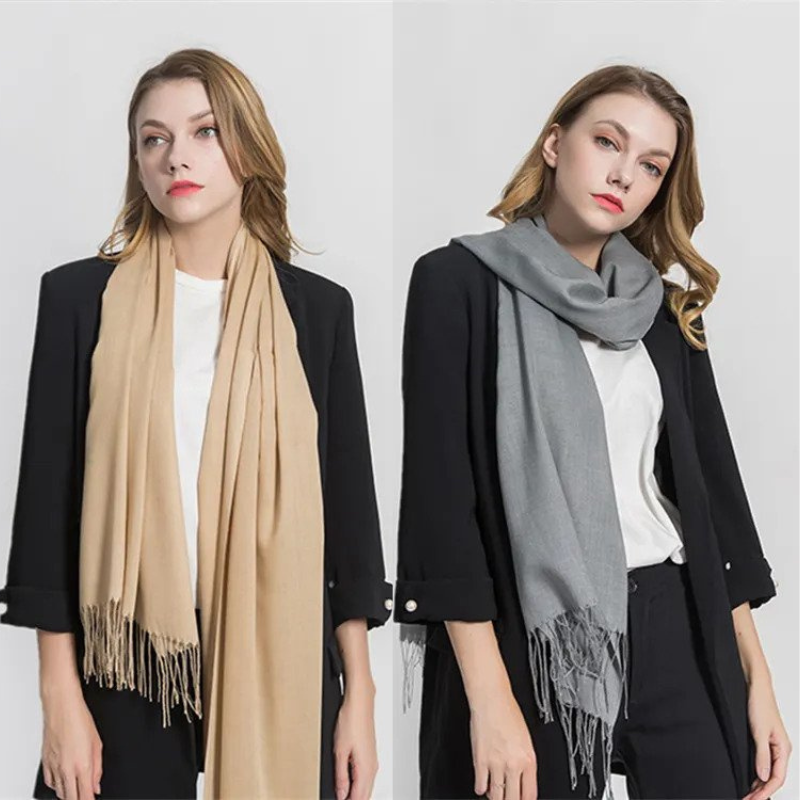 Women modeling beige and gray winter scarves
