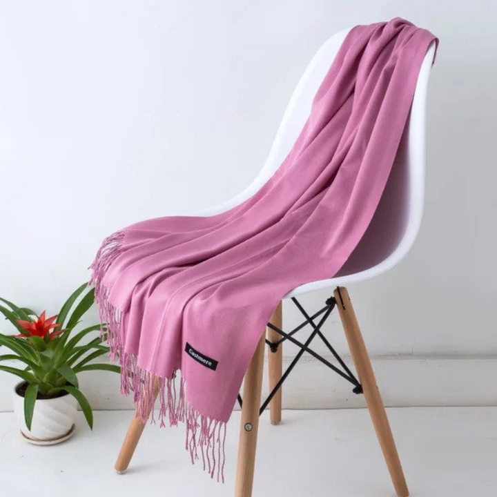 Outdoor portrait of a woman styling the cozy wrap scarf