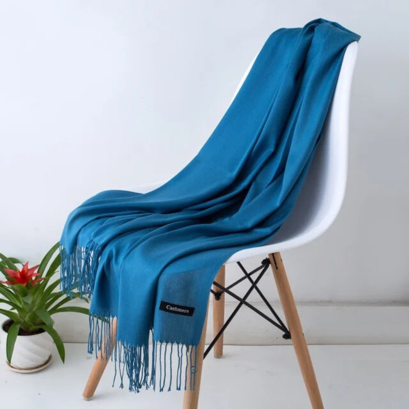Action shot of a woman adjusting her stylish Sylvania winter scarf