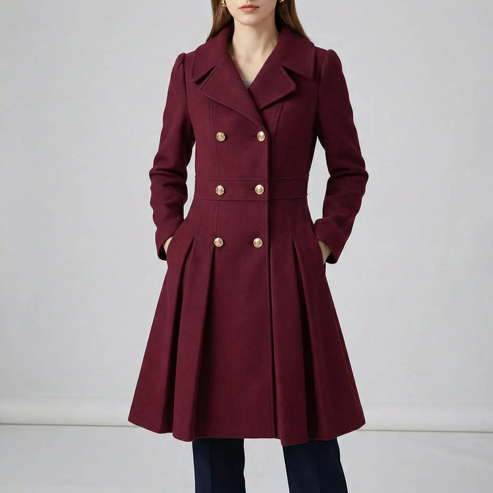 Studio shot of a wine red women's tailored short coat with notched lapel collar and pleats.