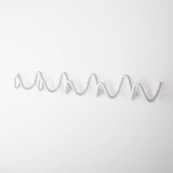 Home decor wall hook wave design displaying colorful scarves and hats