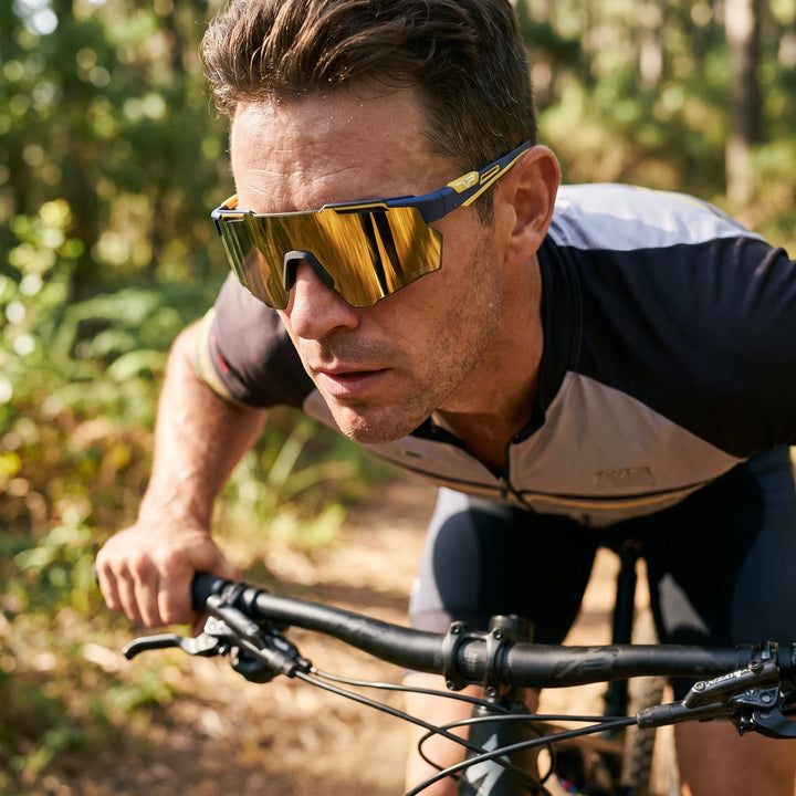Cyclist wearing photochromic wraparound cycling glasses on a trail