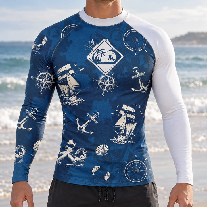 Man wearing a blue nautical pattern long sleeve rashguard on a beach