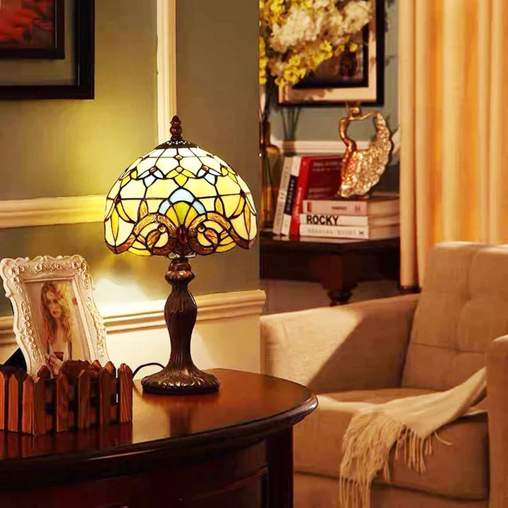 Warm bedside lamp with decorative stained glass and metal base