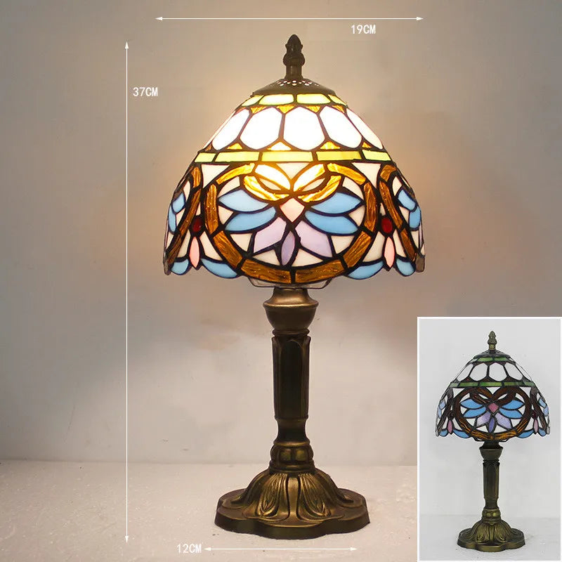 Stained glass desk light turned on in a dimly lit room