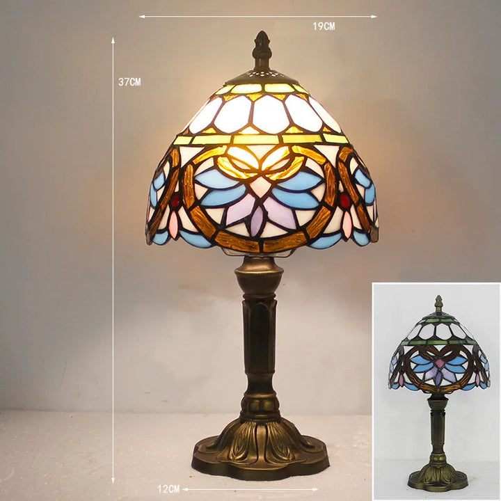 Stained glass desk light turned on in a dimly lit room