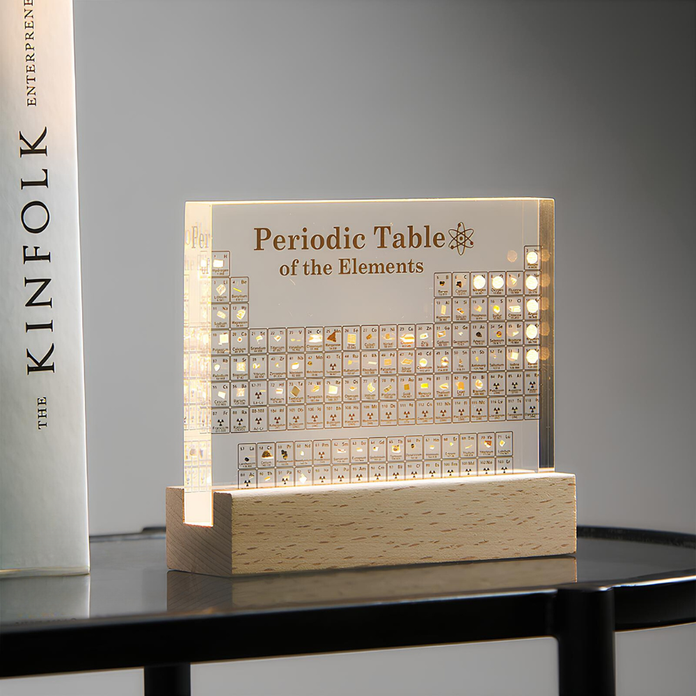 Acrylic periodic table of elements lamp glowing on a wooden base for science decor