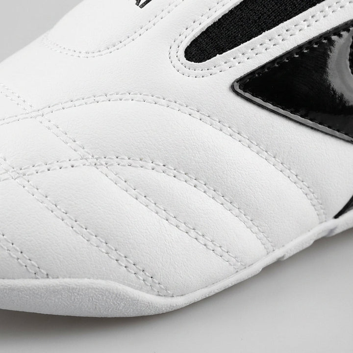 Detailed view of the stitched upper and textured design on white sports shoes