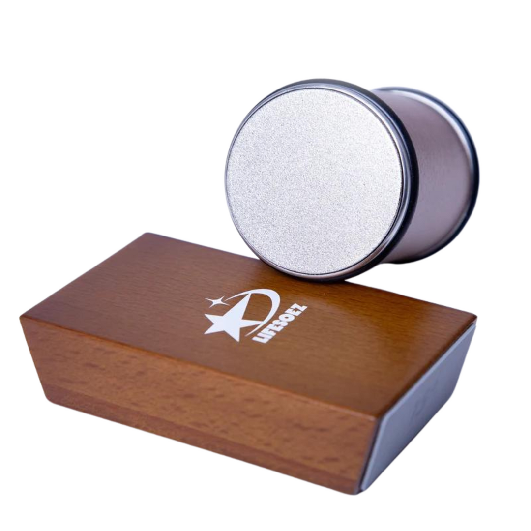 Rolling knife sharpener cylinder resting on a wooden magnetic angle block