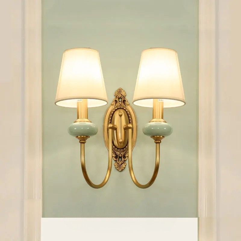 Elegant bedroom wall light with polished copper finish and warm glow