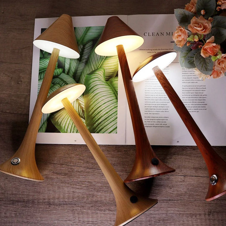 Assorted styles and color finishes of mushroom table lamps displayed on a table