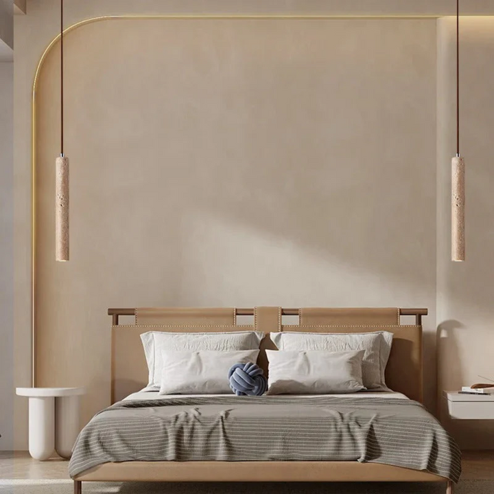 Travertine pendant lights installed above a modern minimalist bedroom headboard