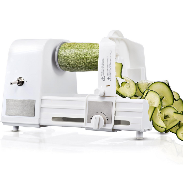 Electric vegetable spiralizer slicing a zucchini into fresh ribbons