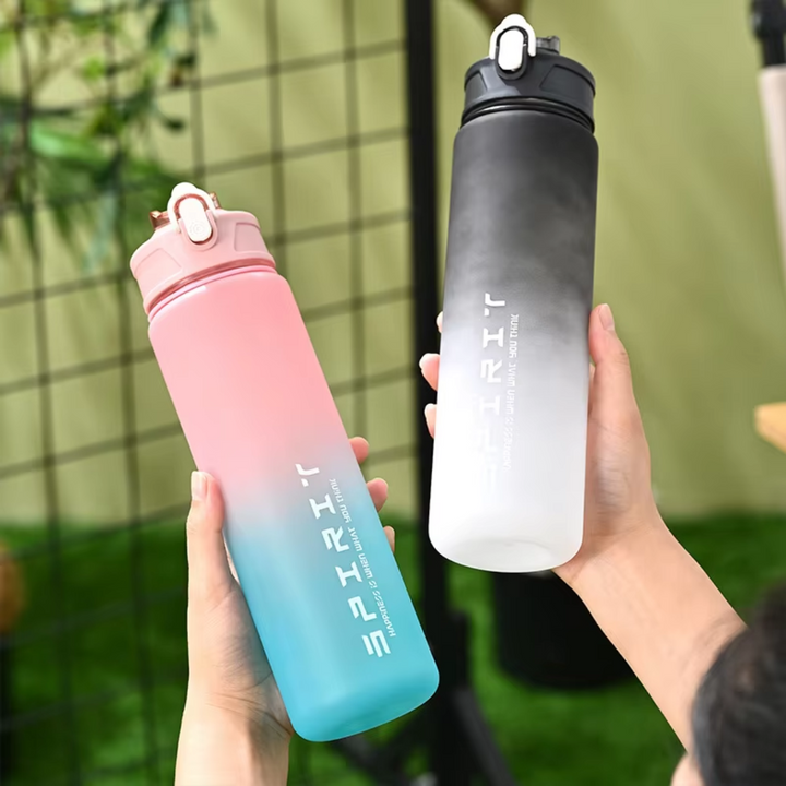Person holding two gradient sports water bottles in pink-blue and black-white