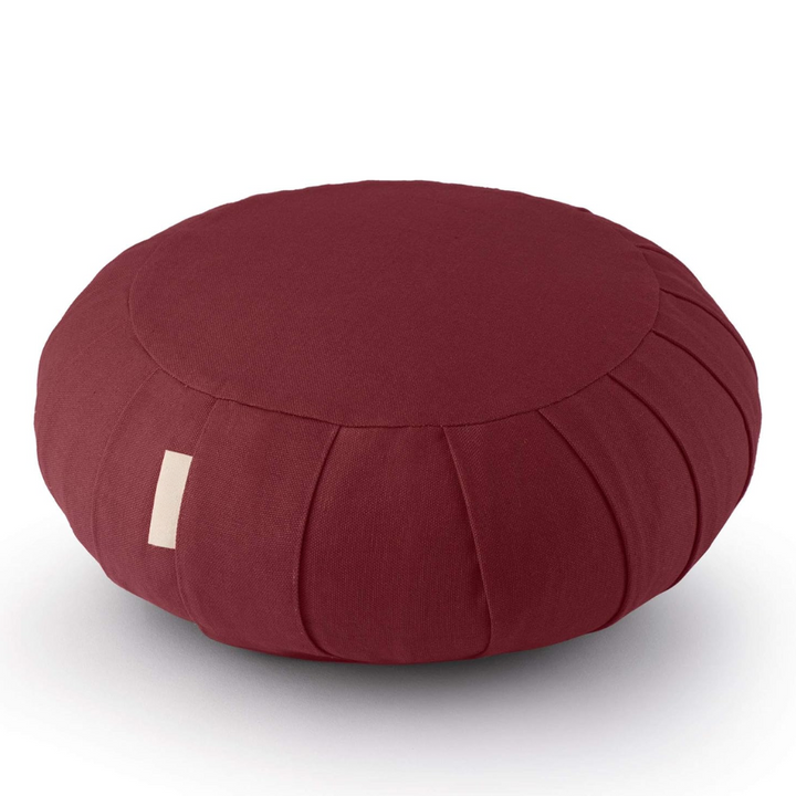 Person sitting comfortably on organic meditation cushion during breathwork