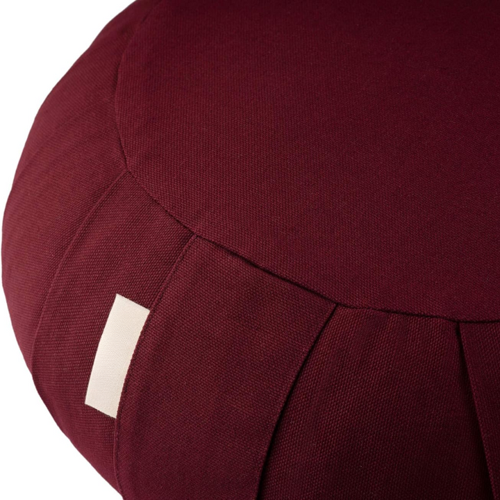 Close-up of durable organic cotton fabric on round mindfulness yoga pillow