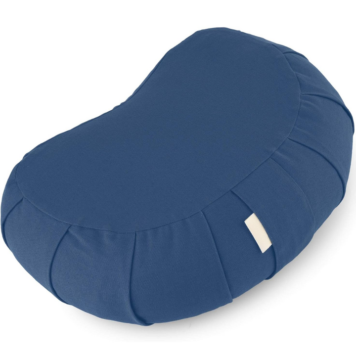 Curved zafu cushion for posture support displayed in a serene home wellness setting