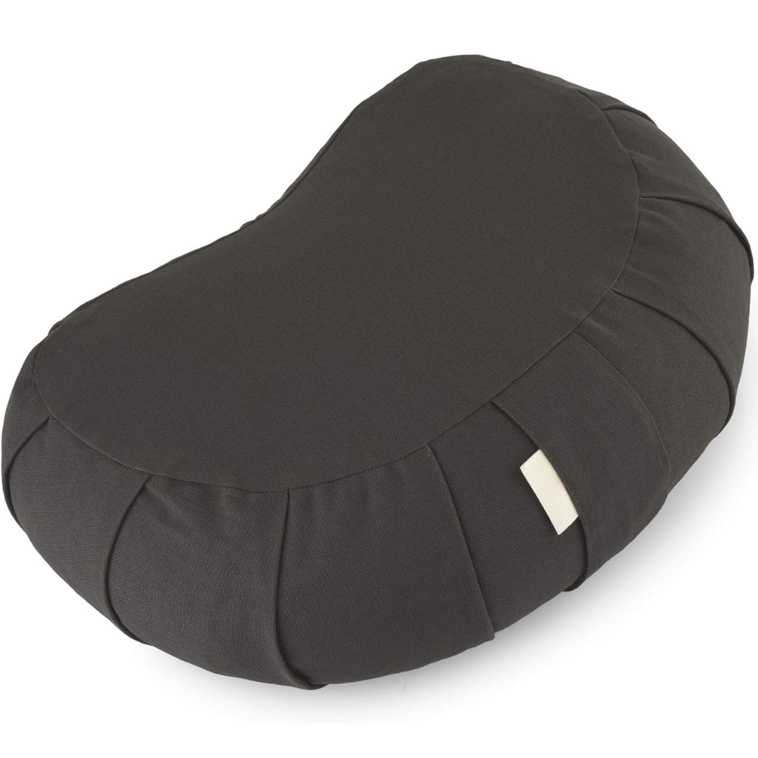 Lifestyle image of zafu cushion providing lower back support during floor sitting