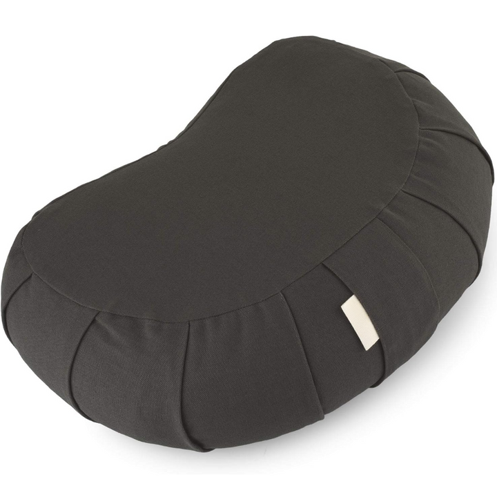 Lifestyle image of zafu cushion providing lower back support during floor sitting
